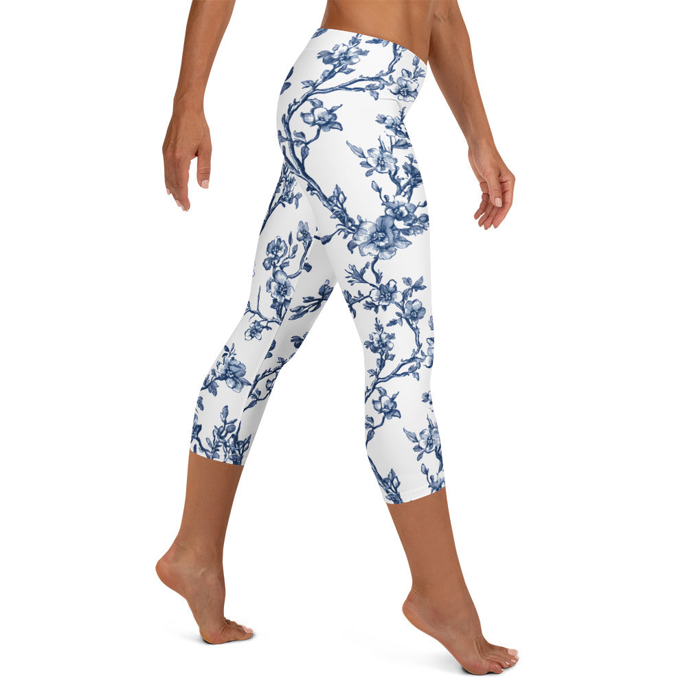 White capri leggings with blue floral vine print, full-leg view