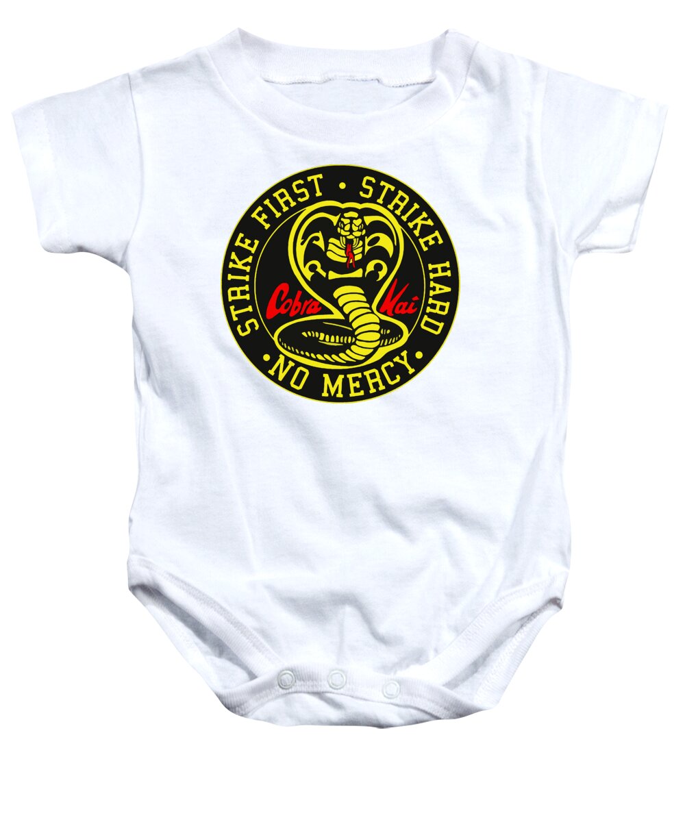 White baby onesie with circular cobra logo on chest