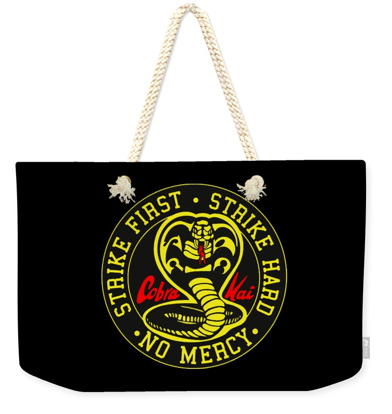 Weekender tote bag with black fabric, white rope handles, and circular emblem print