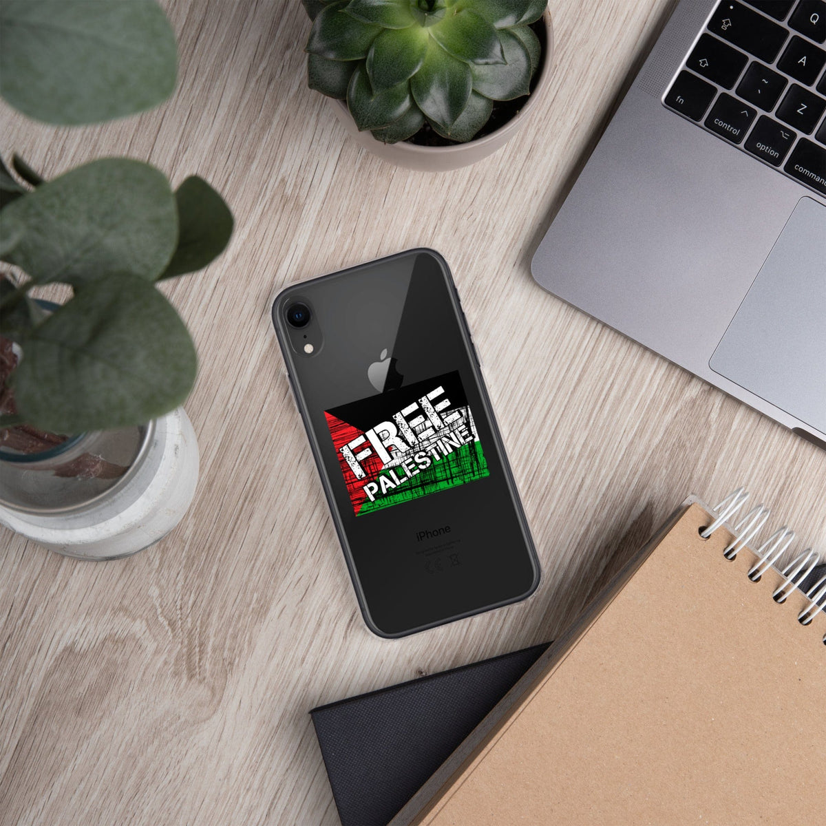 Clear iPhone case with “FREE PALESTINE” graphic on dark phone back