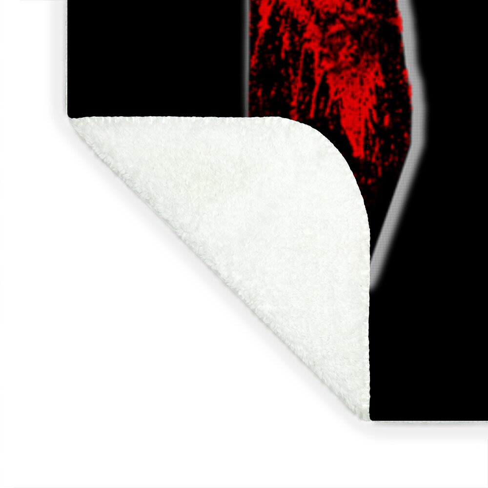 Corner of horror blanket: black side with red “3” print and white plush underside