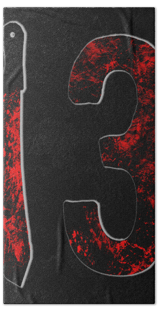 Bath towel with dark gray fabric and large red splatter design in stylized outlines