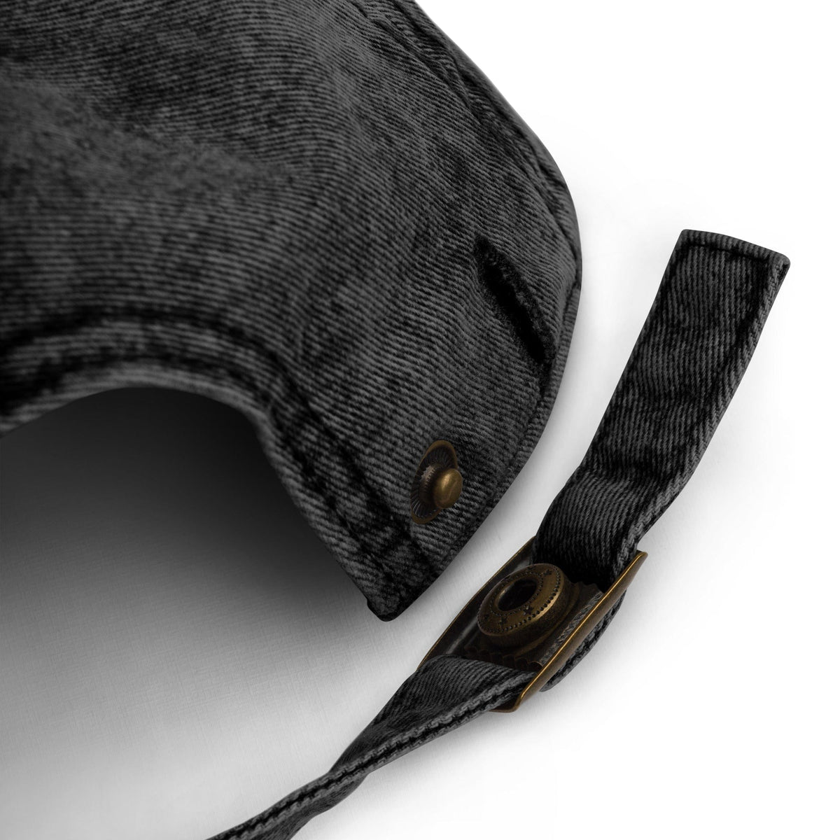 Black cotton twill cap brim detail with stitched edge and metal eyelets