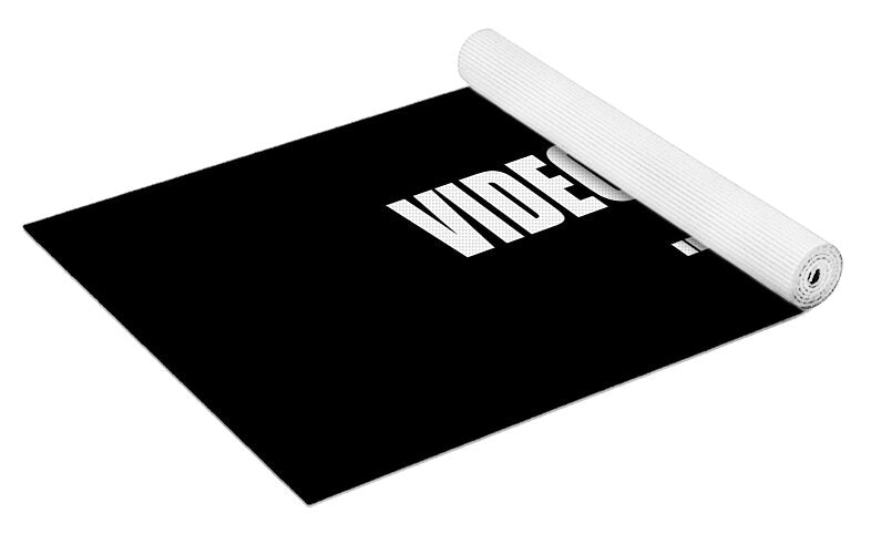 Black Videodrome yoga mat with unrolled surface and rolled top corner