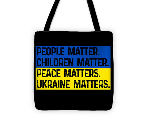 Black tote bag with centered slogan text on blue and yellow flag-style panel, handles