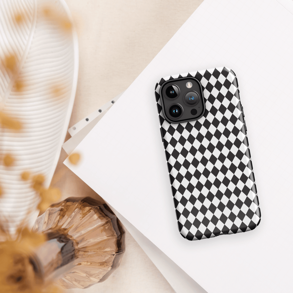 Black-and-white diamond check iPhone case with raised camera bump protection