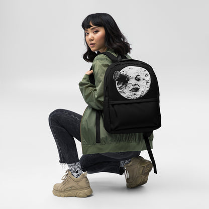 Black backpack with moon face graphic, front view, worn on back