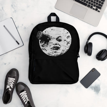 Black backpack with moon face graphic, front view laid flat
