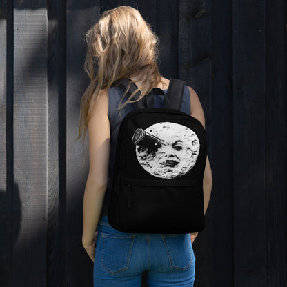 Black backpack with moon face graphic, worn on back with front top pocket