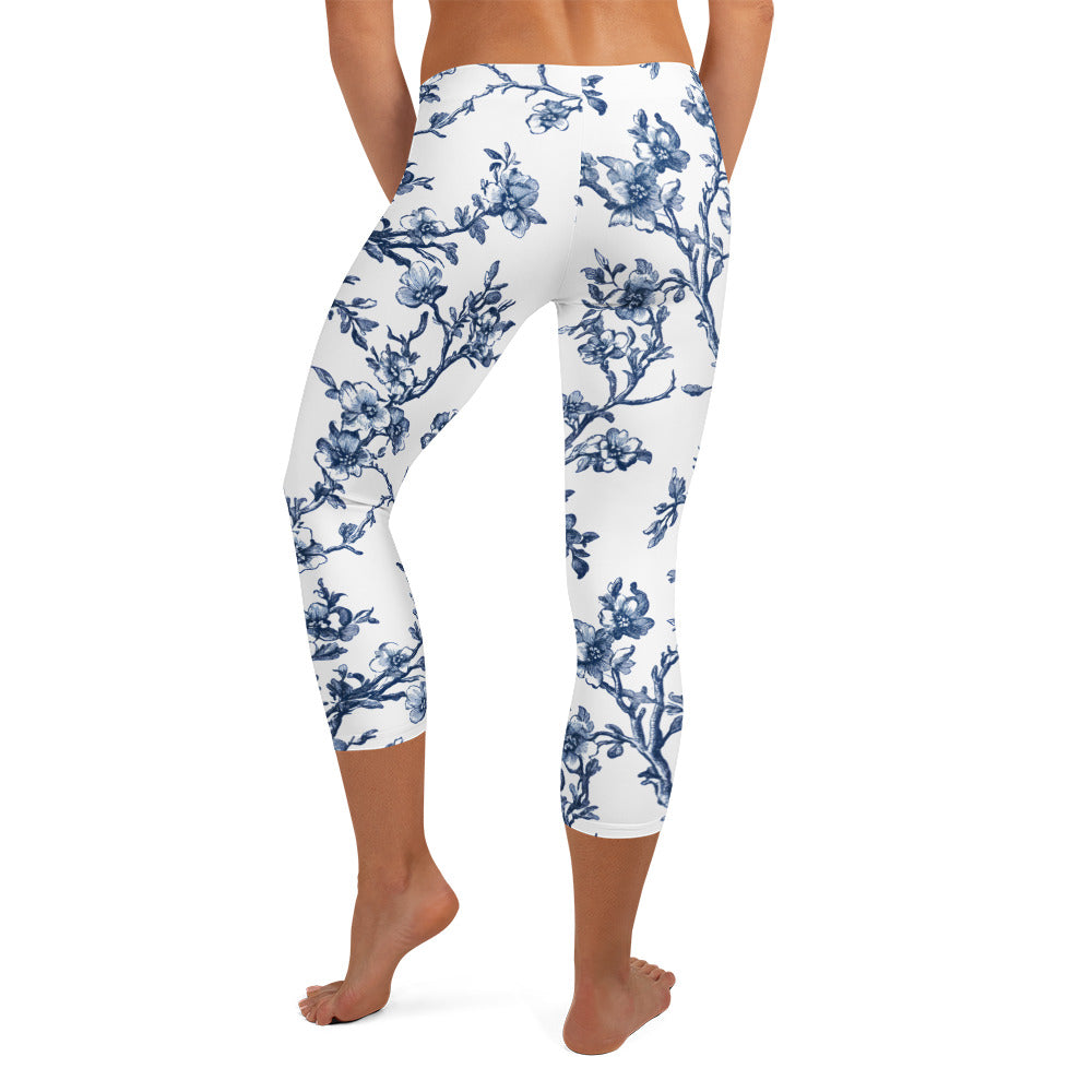 White capri leggings with blue floral vine print, cropped mid-calf.
