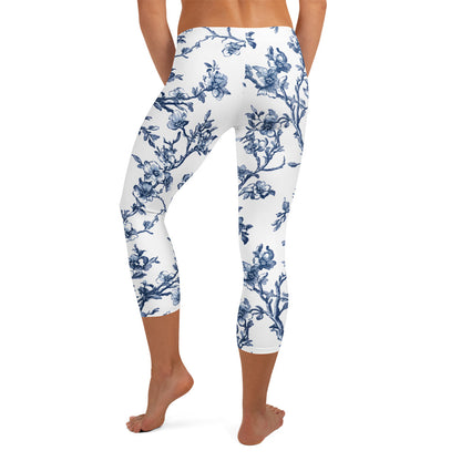 White capri leggings with blue floral vine print, cropped mid-calf.