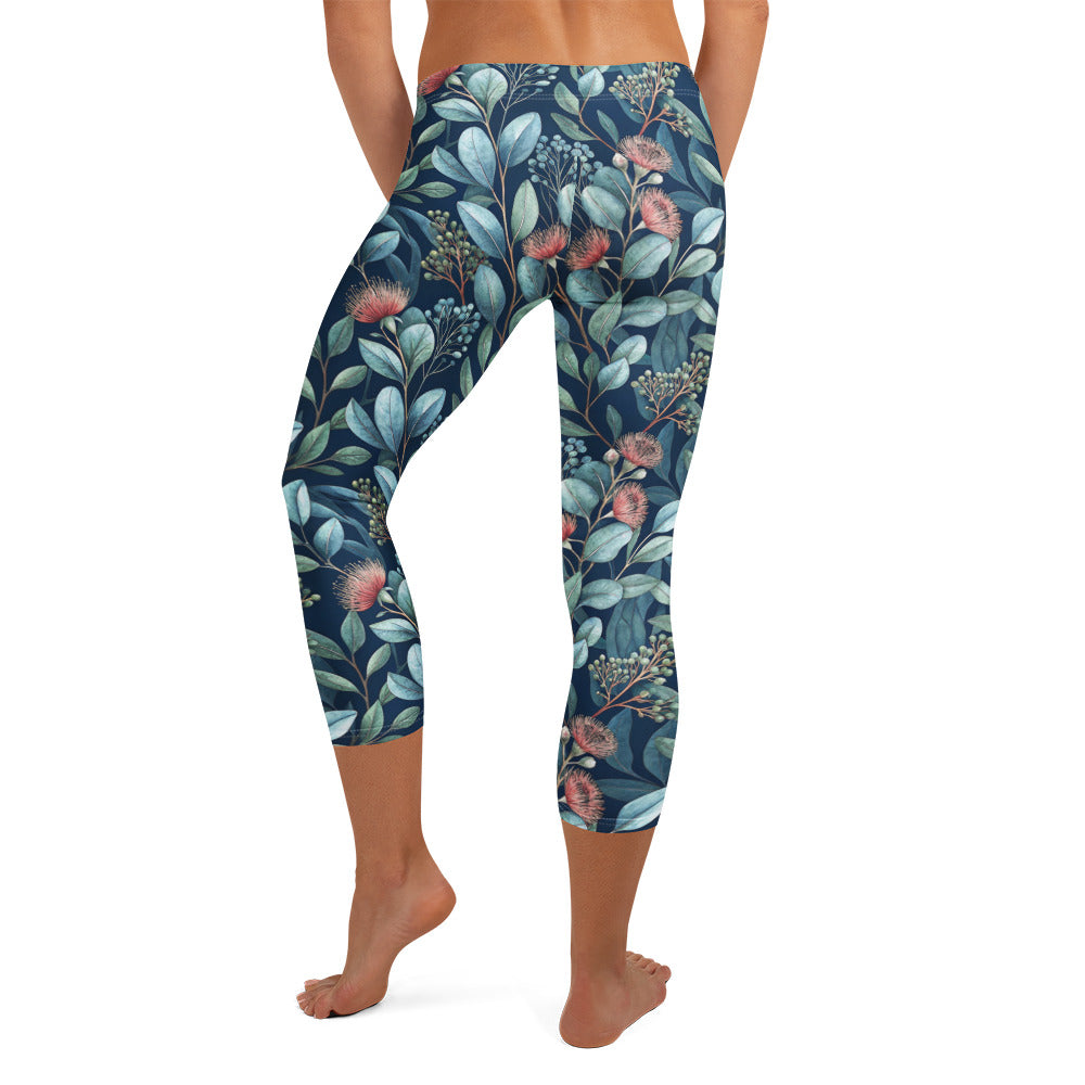 Botanical capri leggings in dark navy with teal leaves and pink flowers, knee-length