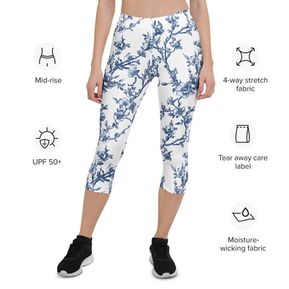 White capri leggings with blue floral print, mid-rise, mid-calf length.