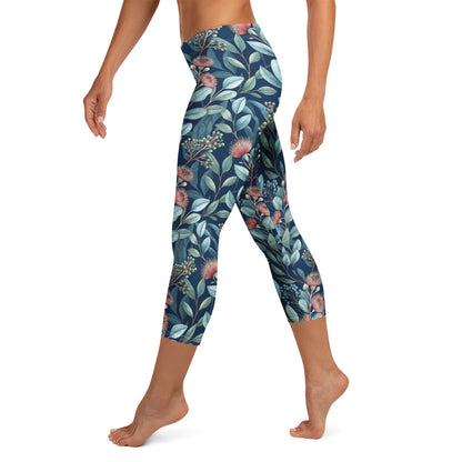 Botanical capri leggings with dark navy background, teal leaves, and pink blossoms