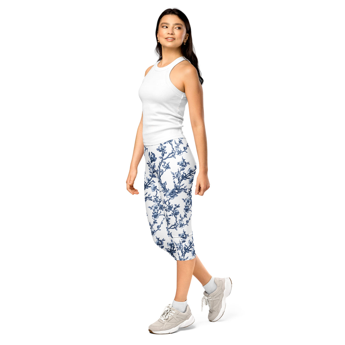 White capri leggings with blue floral print, mid-calf length, worn with sneakers.