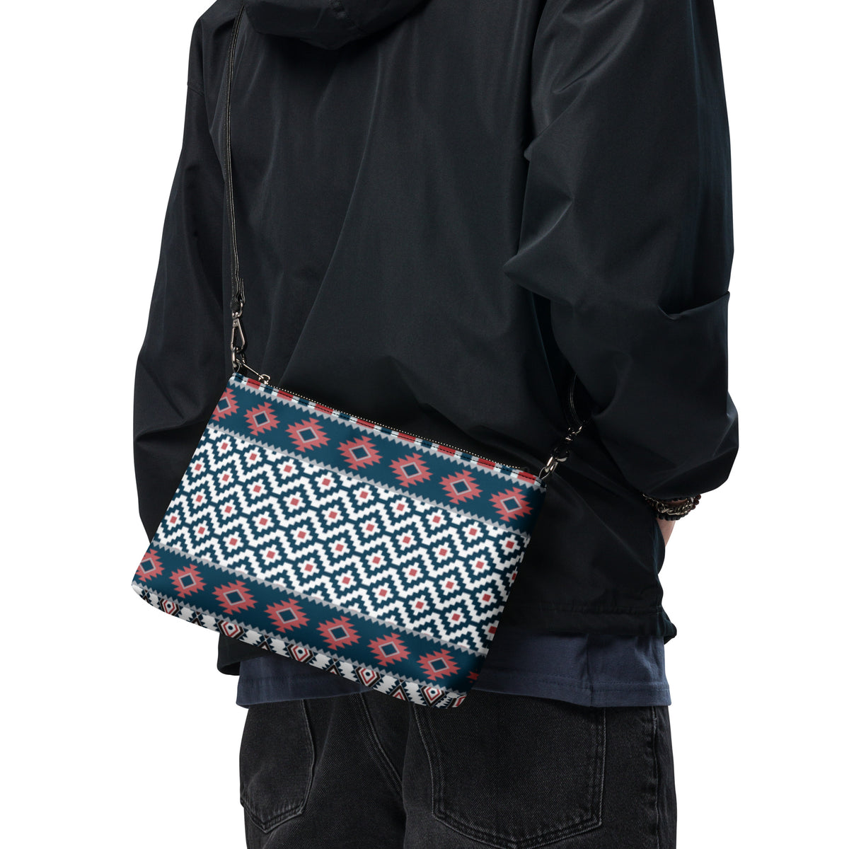 Aztec-pattern crossbody bag worn crossbody on person in a dark jacket