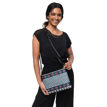 Aztec-pattern crossbody bag worn on shoulder strap with blue, red, and white stripes