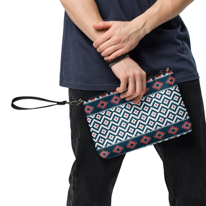 Aztec-pattern crossbody bag with zip top in hand, featuring blue, red, and white geometric print