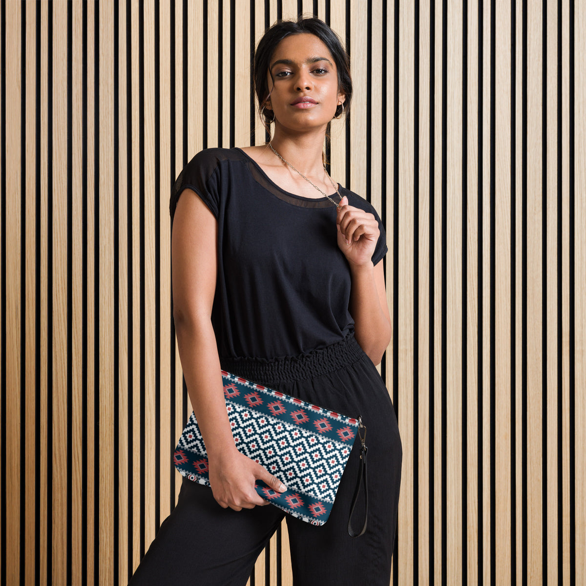Geometric patterned crossbody bag with black zipper and adjustable strap, worn across body