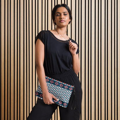 Geometric patterned crossbody bag with black zipper and adjustable strap, worn across body