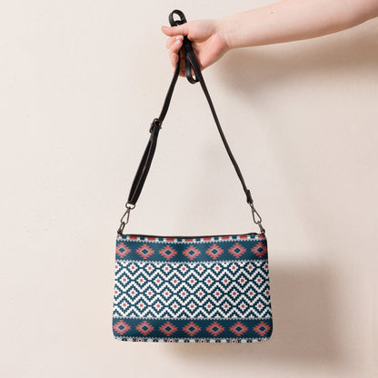 Geometric patterned crossbody bag with black top zipper and shoulder strap, shown front