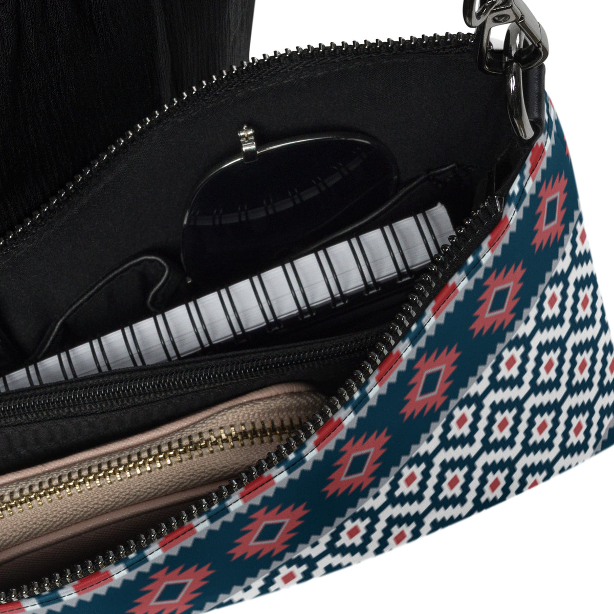 Interior view of zippered crossbody bag showing black lining and blue-red-white exterior print