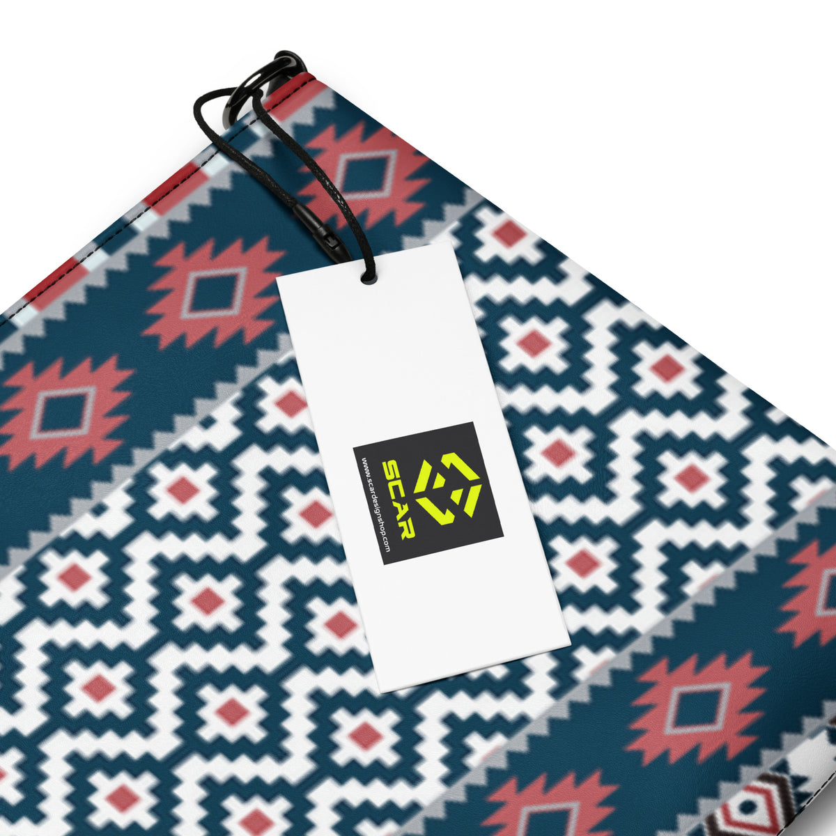 Fabric close-up of geometric pattern crossbody bag in blue, white, red, and black