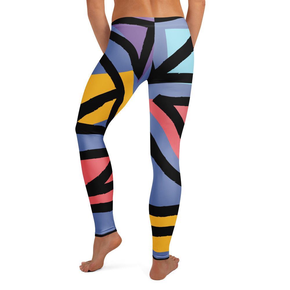 Geometric pattern leggings, close view of blue fabric with black, yellow, and pink shapes.