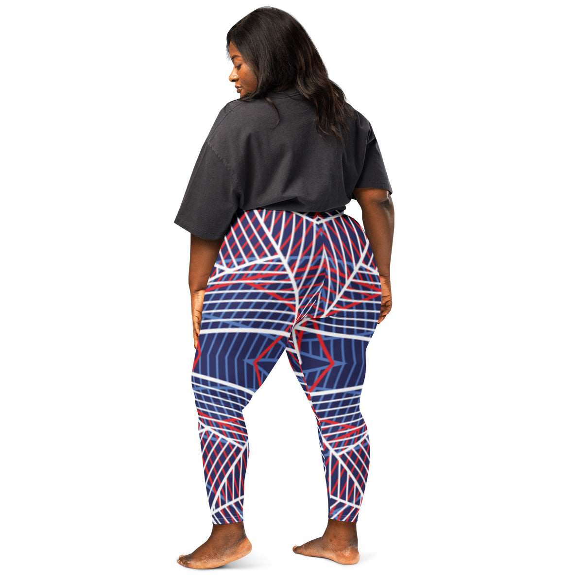 Women’s navy leggings with red and white abstract line pattern, side/back view.