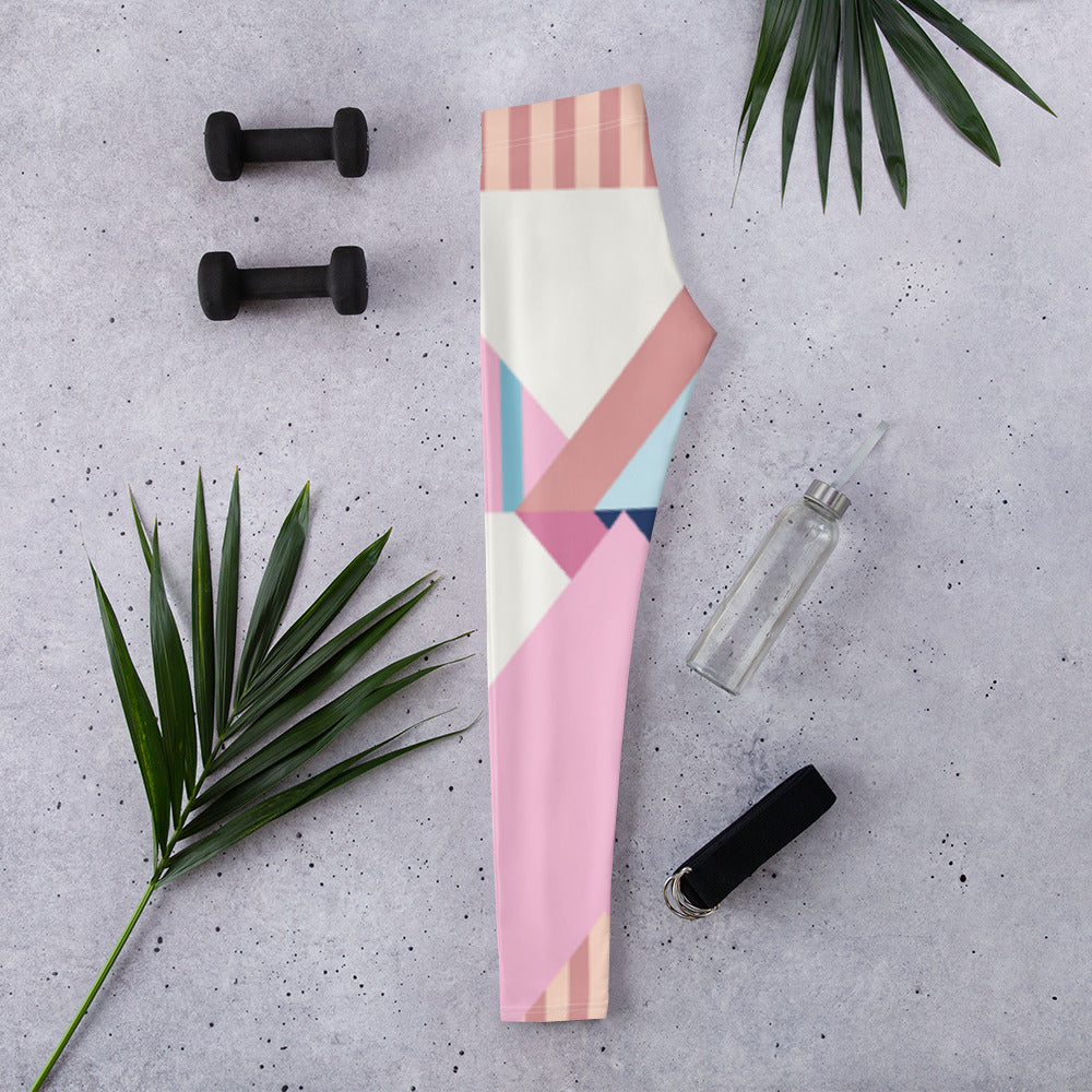 Folded women’s leggings with pastel geometric print stripes and blocks, full length.