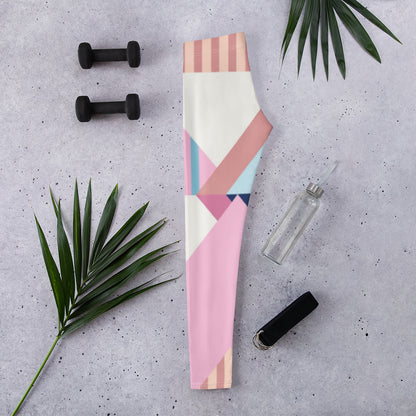 Folded women’s leggings with pastel geometric print stripes and blocks, full length.