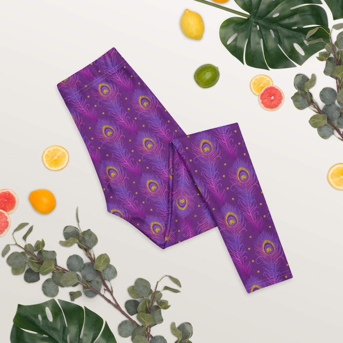 Purple leggings laid flat with peacock-eye feather pattern