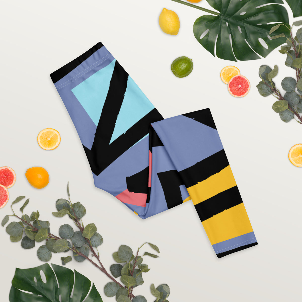 Folded geometric leggings with blue, black, yellow, and pink stripe pattern