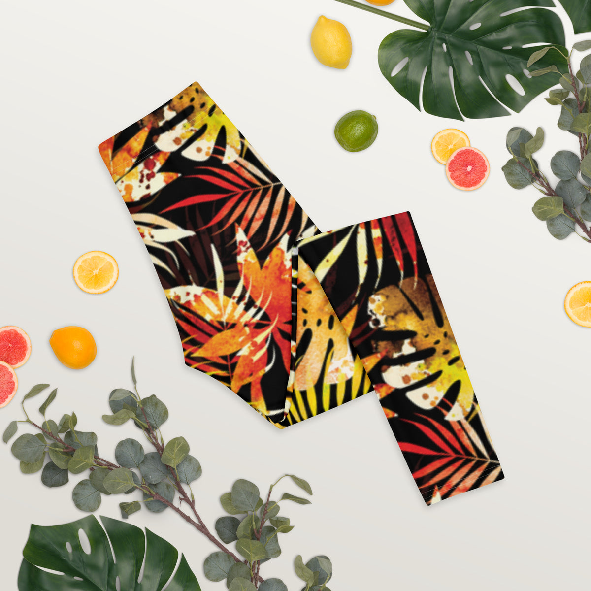 Women's tropical leaf print leggings with multicolor allover pattern on dark fabric