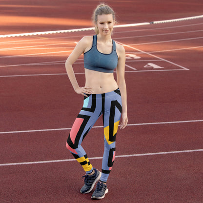 Geometric print leggings in blue with black, yellow, and pink accents, worn for sport.