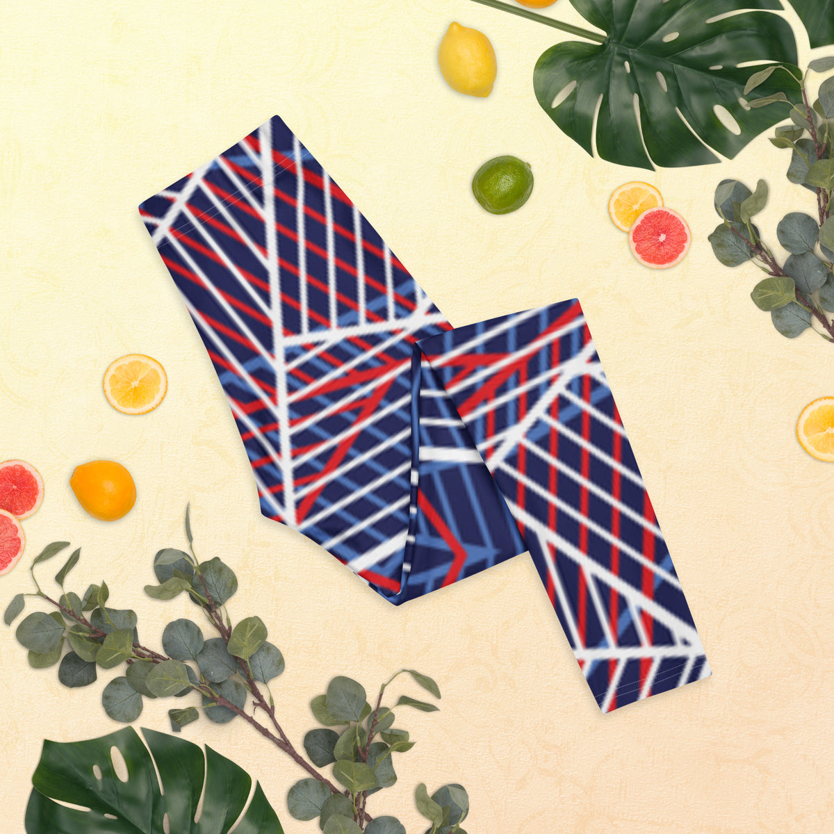 Folded women’s leggings with navy and red/white abstract line print, front laid flat.