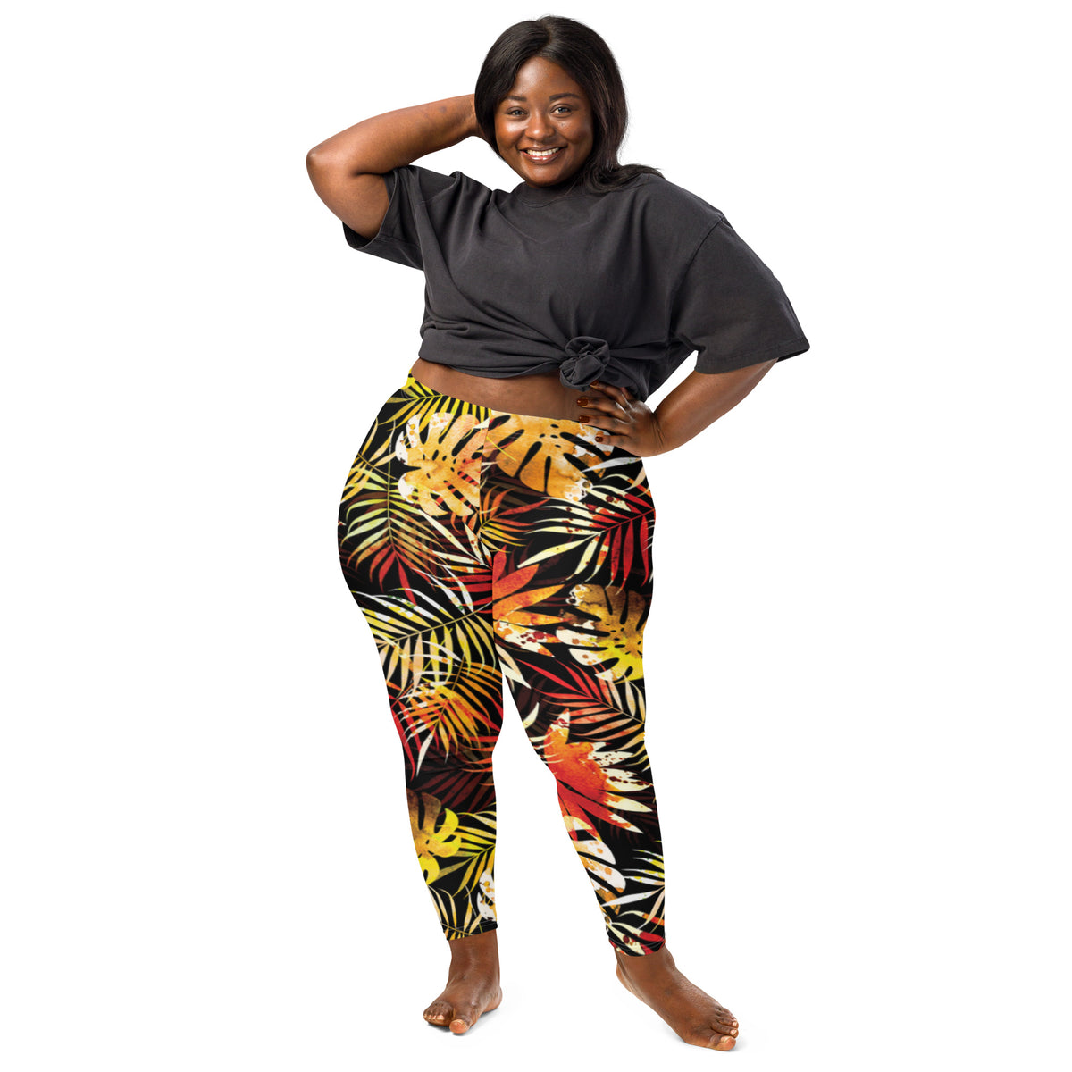 Women's tropical leaf print leggings with multicolor tropical foliage on dark base