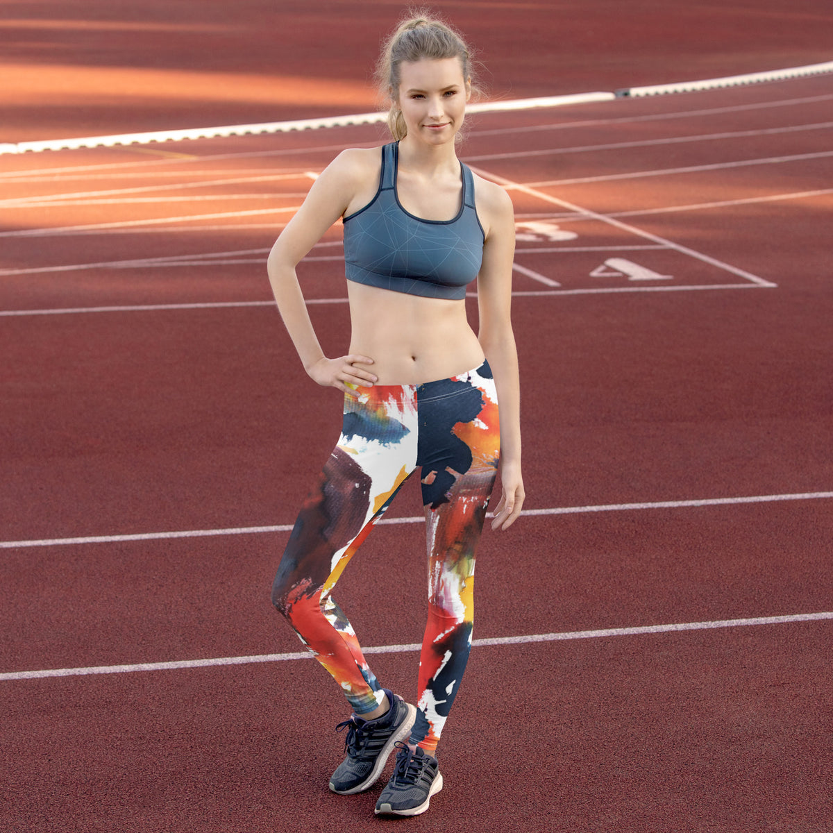 Women’s active leggings with navy base and red, yellow, and white paint splashes