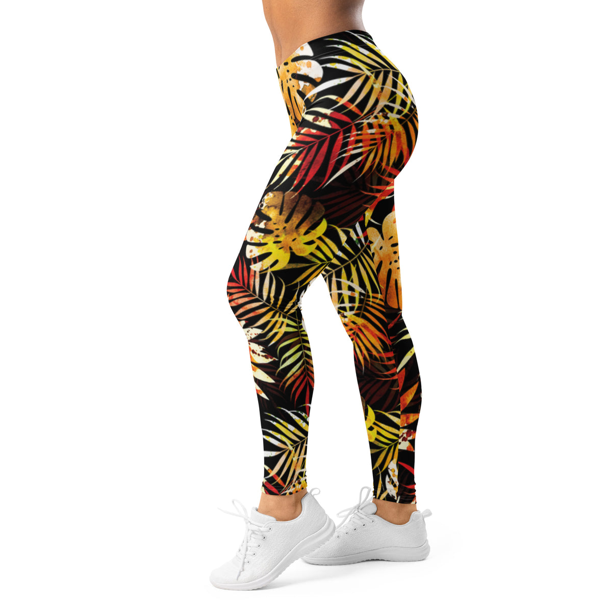 Women's leggings, side view, with black base and bright tropical leaf print