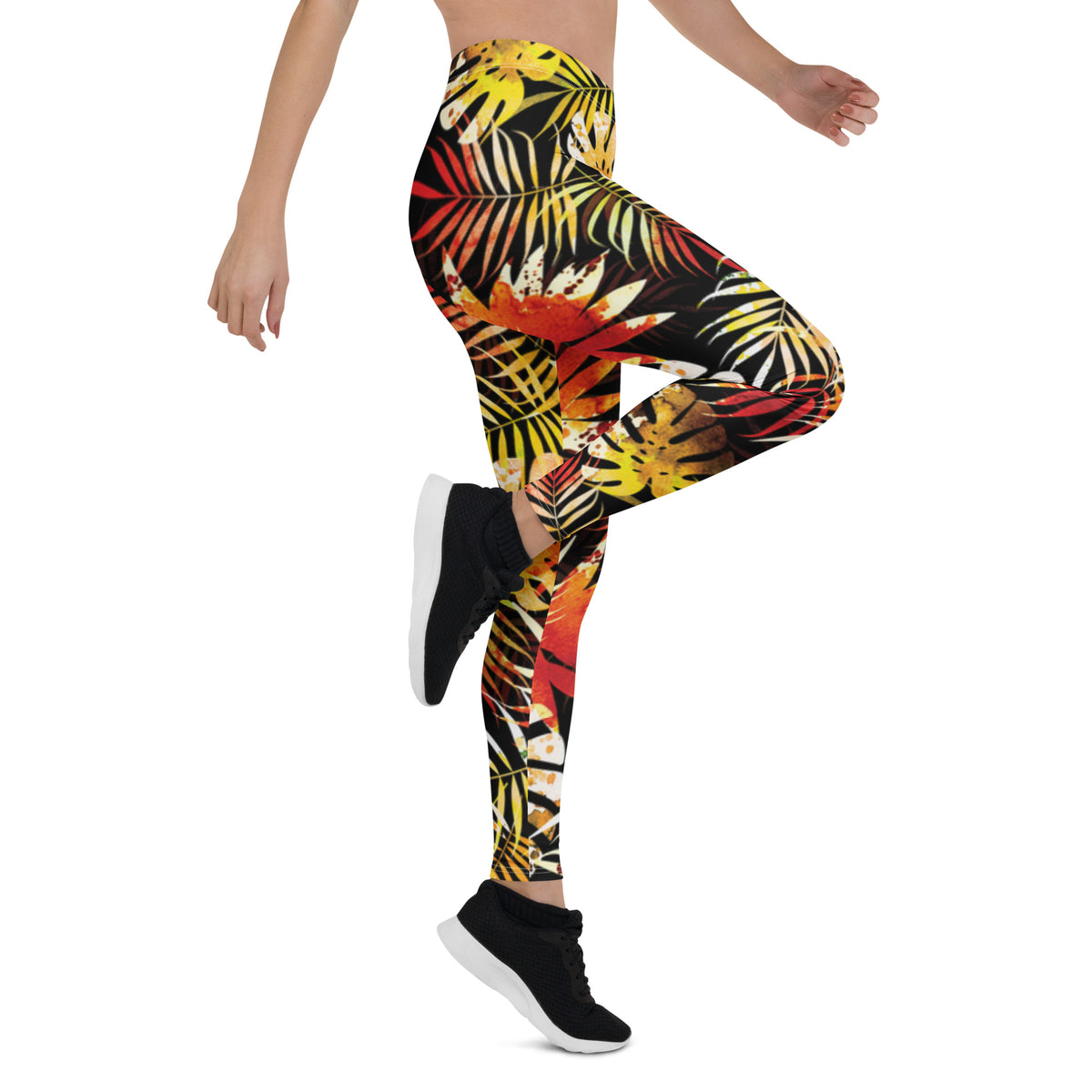 Women's tropical leaf print leggings with multicolor foliage on dark fabric