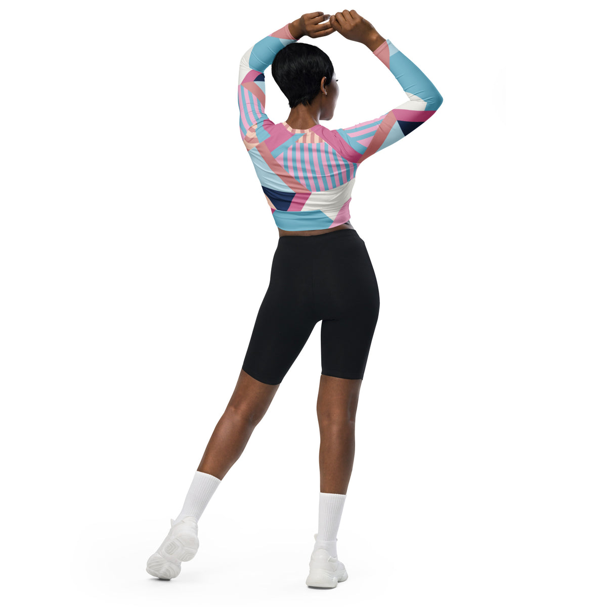 Long-sleeve crop top with multicolor geometric stripe pattern in pink, blue, and white