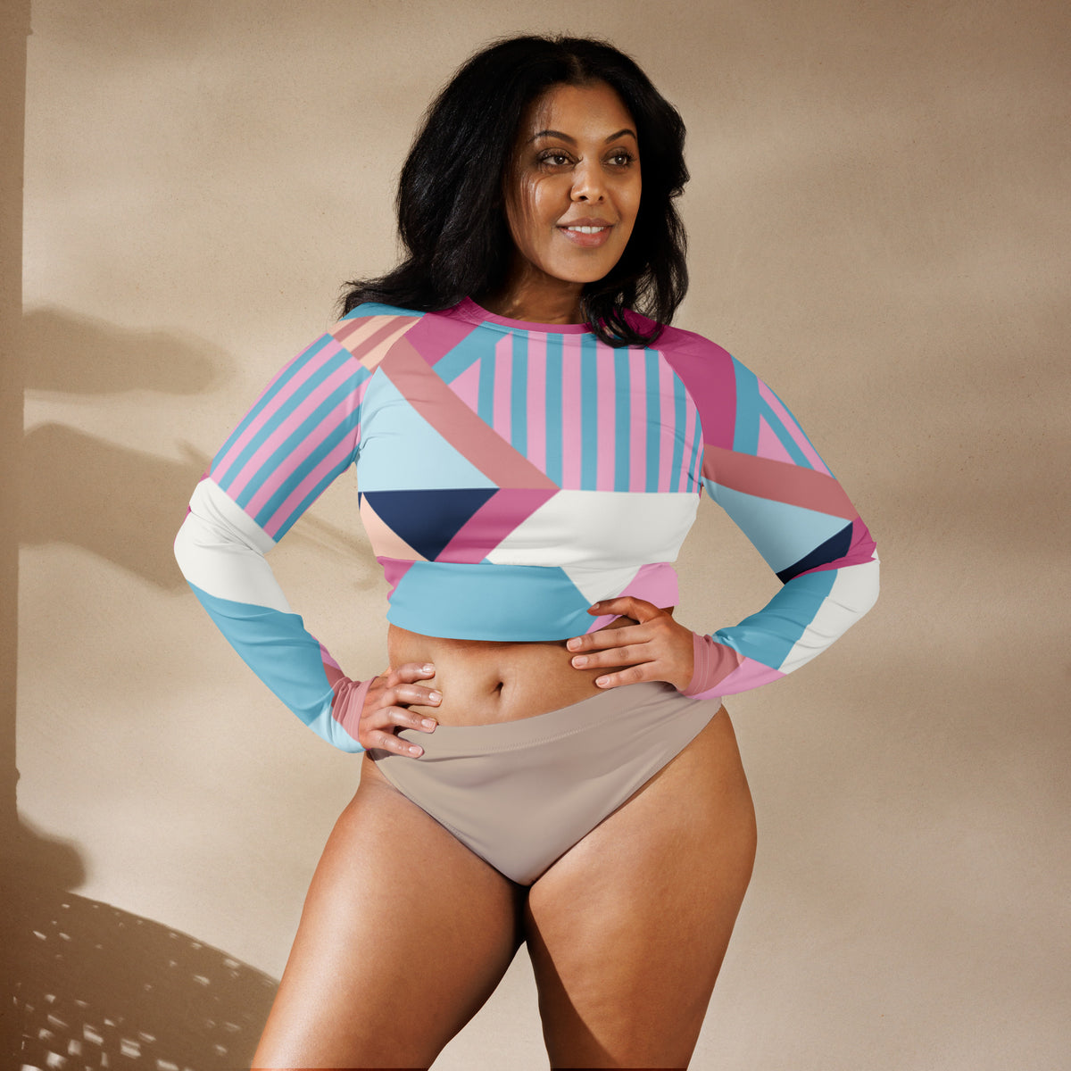 Long-sleeve crop top featuring pink, blue, and white geometric print