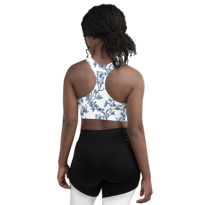 Longline sports bra with blue floral racerback, open-back styling and wide hem