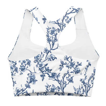 Longline sports bra flat lay, white with blue floral print and wide V-neck