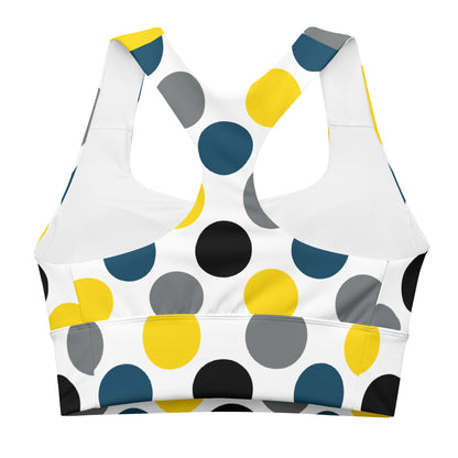 Longline sports bra with white base and multicolor polka-dot print, front view.