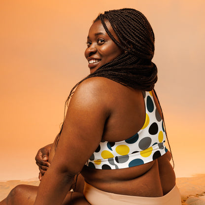 Longline sports bra with multicolor polka dots on white, back view with racerback straps.