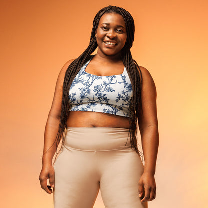 Longline sports bra with blue floral print, wide straps, and fitted support