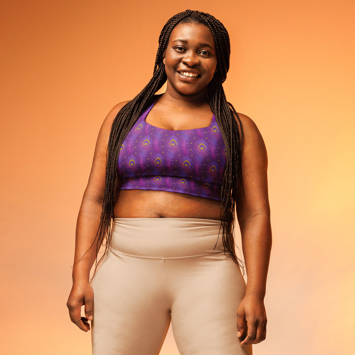 Purple peacock-feather longline sports bra worn by model, racerback style