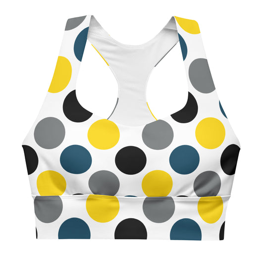 Longline sports bra with white base and multicolor polka-dot print, wide chest band.
