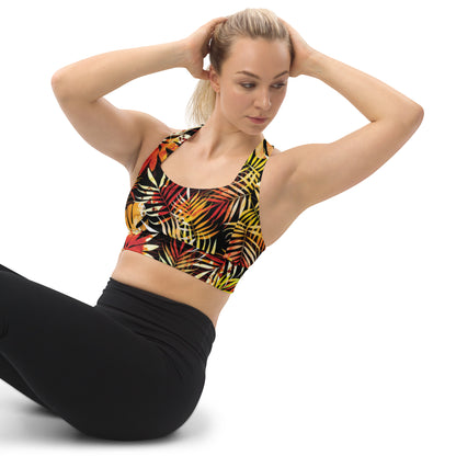 Longline sports bra with tropical leaf print, scoop neckline and racerback on black with red and yellow